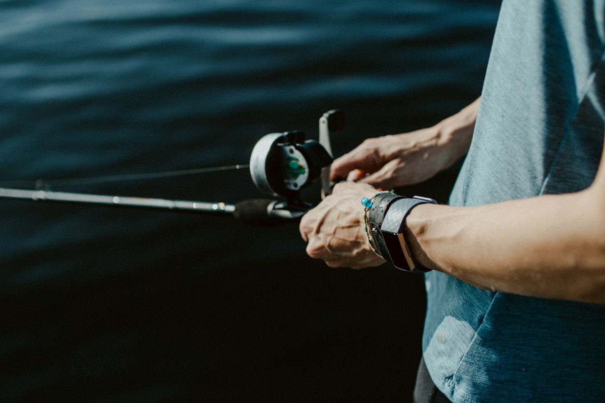 Angler holding a fishing rod by the water